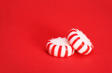 Peppermint Candy over Red Christmas background. Macro.