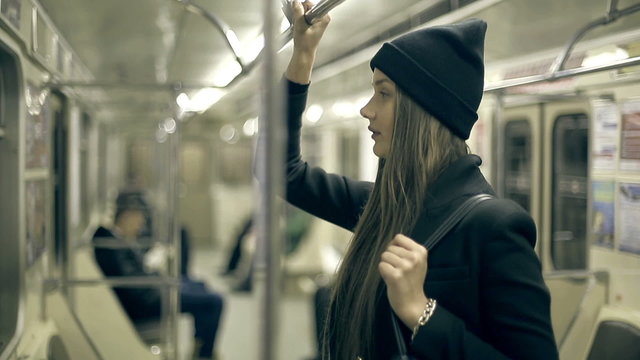 Teen girl rides the metro at night