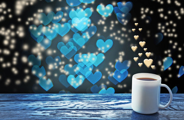 Cup of hot drink on bright background