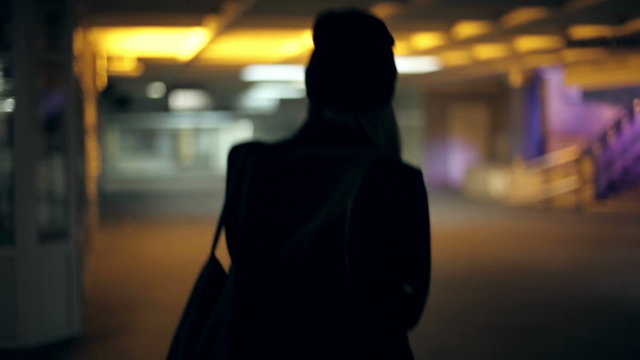 Girl teenager goes at night in the underpass