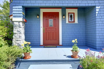 Fototapeta na wymiar Blue entrance porch with red door.