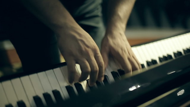 A man playing a melody on the piano