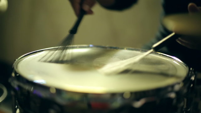 The drummer plays brushes on a drum solo