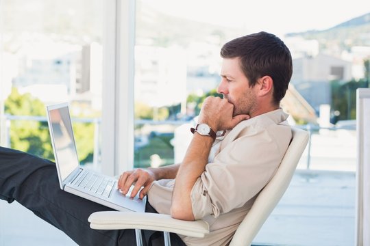 Relaxed businessman with a laptop