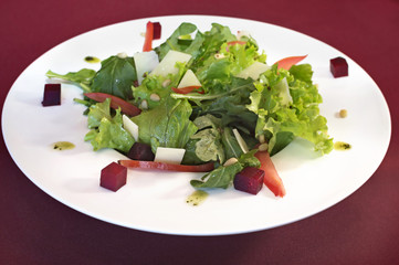Vegetarian salad with beet on white plate