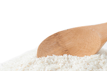Rise with a wooden spoon on white background