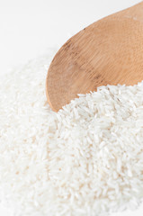 Rise with a wooden spoon on white background