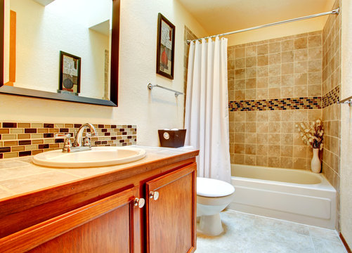 Bathroom interior with beige tile wall trim
