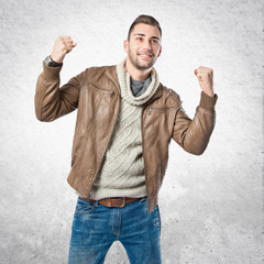 Fototapeta premium Young man winner over isolated white background