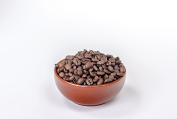 brown bowl with coffee beans on a heap