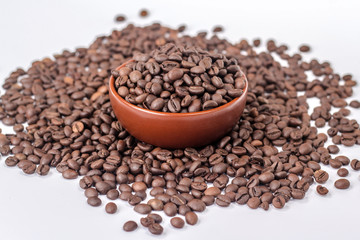 brown bowl with coffee beans on a heap