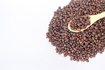 wooden spoon full of coffee beans