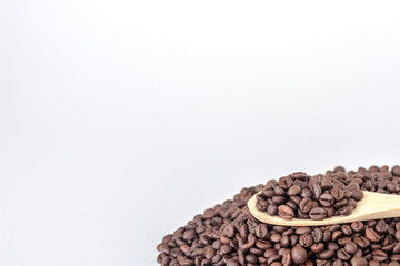 wooden spoon full of coffee beans