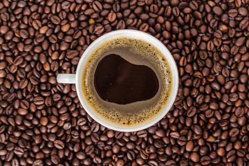 cup of coffee on the background of bean