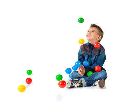 Kid playing with colored balls