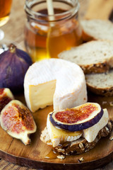 Breakfast setting with bread, cheese, figs and honey