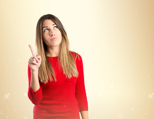 Cute young girl thinking an idea over isolated white background