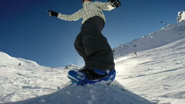 snowboarder on track in alpine mountains