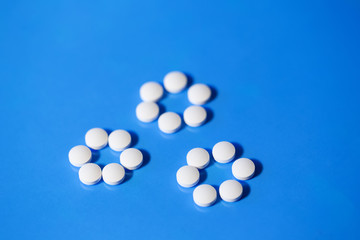 pills. White medical pills on blue background