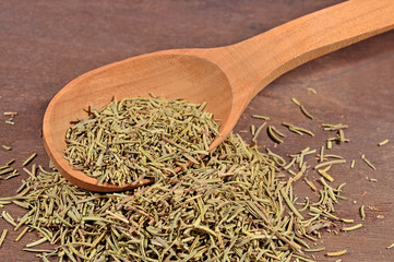 Dried rosemary in a spoon
