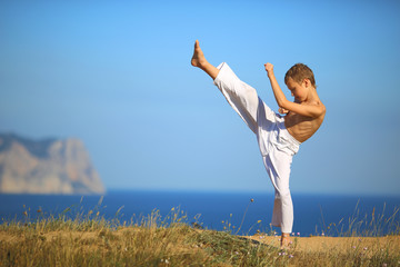 boy karate on the coast - 74183661