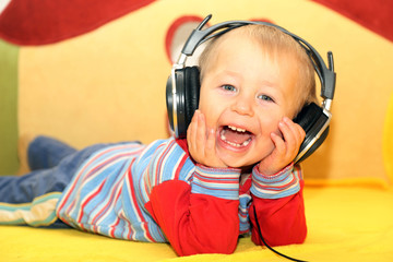 funny kid listening to music in headphones