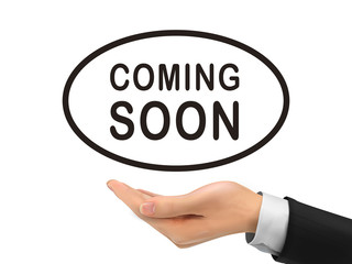 coming soon words holding by realistic hand