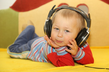 funny kid listening to music in headphones