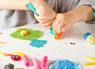 Child hands  with colorful clay