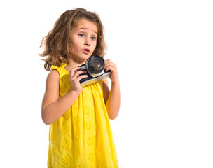Obraz premium Blonde little girl photographing something