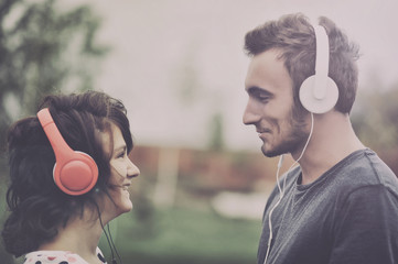 Boy and girll listening to music on headphones