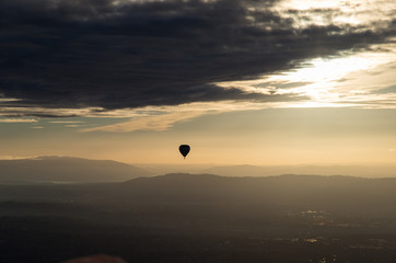 Silhouette of hot air balloon over Melbourne