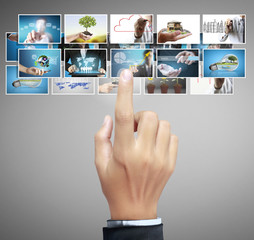 Man pushing on a touch screen digital photos