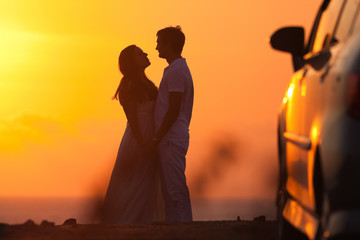 Sunset background of silhouette couple