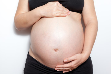 Closeup of pregnant woman, isolated on white