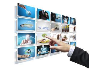 Man pushing on a touch screen digital photos