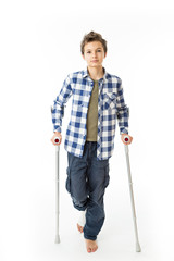 Teenage Boy with crutches and a bandage on his right leg