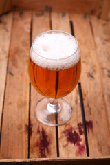 Glass of beer in a crate