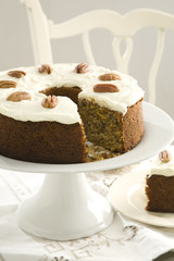 Delicious carrot cake with a slice taken out.