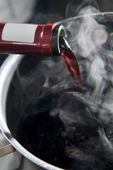 Red wine poured into a pot