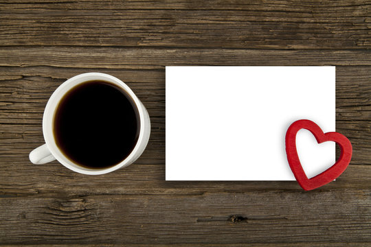 cup of coffee and paper sheet with a heart