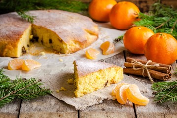 Christmas piece of biscuit cake with mandarin and cinnamon