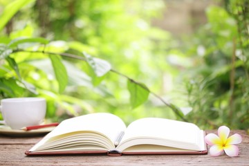 Notebook  and coffee on wooden table