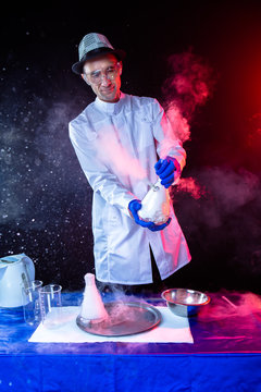 Smiling man scientist with dry ice