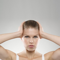 Portrait of woman touching her painful temples. Insomnia concept