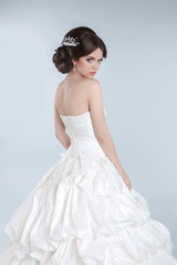Fototapeta na wymiar Beauty Fashion young bride model posing in wedding dress with ha
