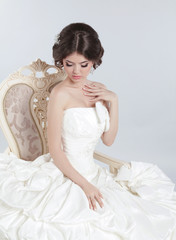 Fototapeta na wymiar Bride. Beautiful brunette woman wearing in modern wedding dress