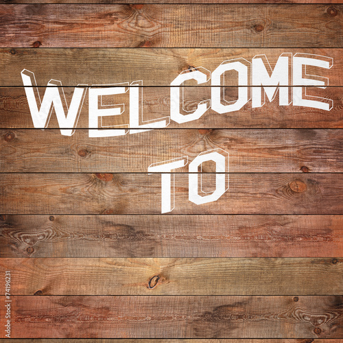 “Vintage WELCOME sign on natural wooden surface.” Stock photo and