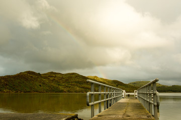 pier or bridge at the lake, view on the mountain