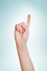 Hand with index finger raised up